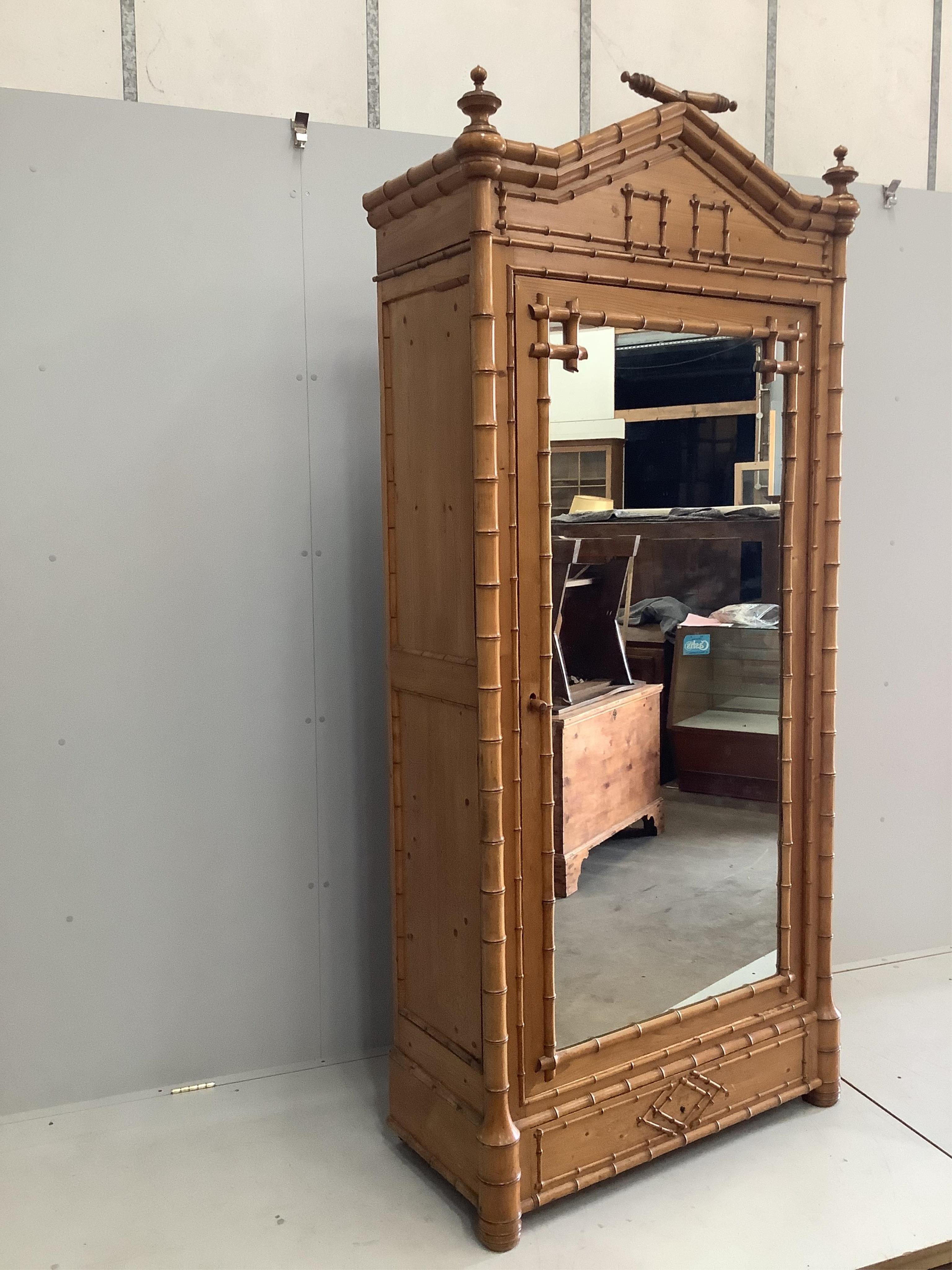 A late Victorian pitch pine faux bamboo mirrored armoire, width 98cm, depth 44cm, height 128cm. Condition - good